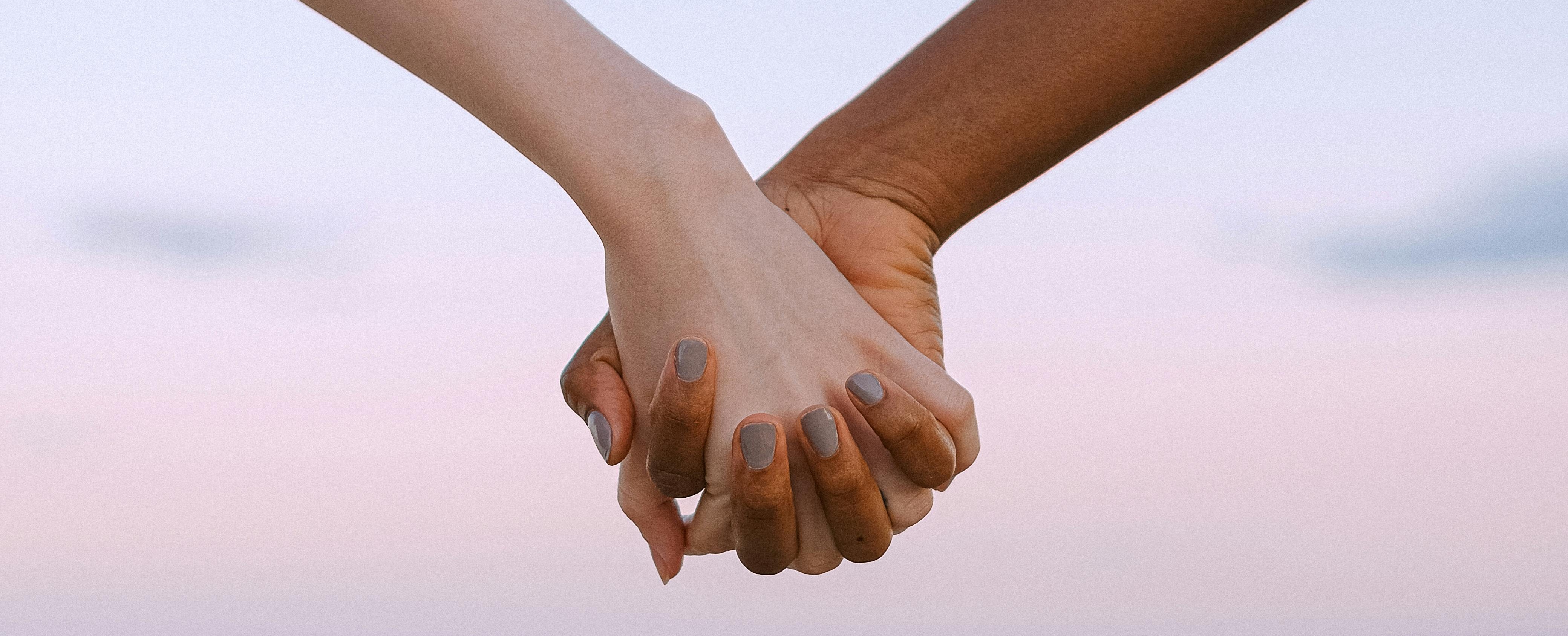 Two people holding hands